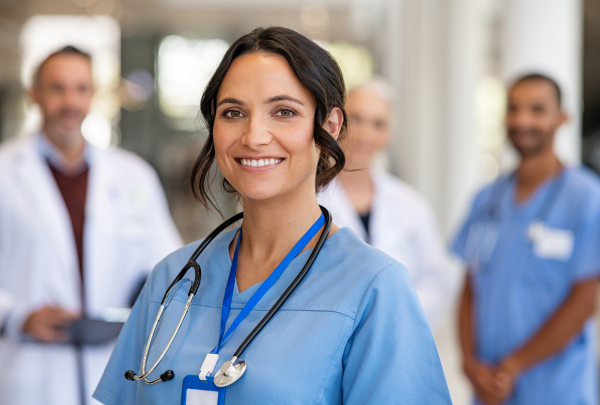 A nurse wearing hospital scrubs, smiling