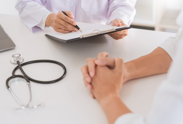 Doctors hands beside a stethoscope