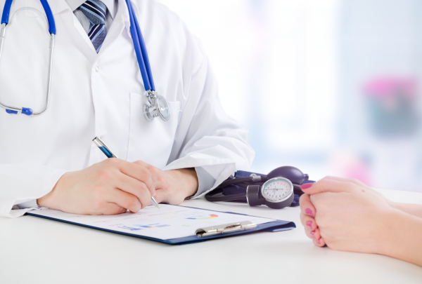 Doctor writing on a clipboard