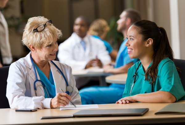 Two female nurses having a chat