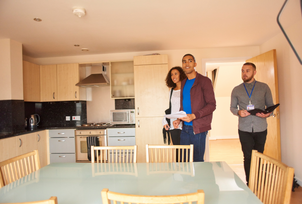 3 people viewing a kitchen during a property inspection