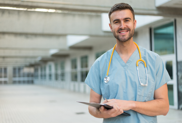 Nurse smiling in a hospital coridor