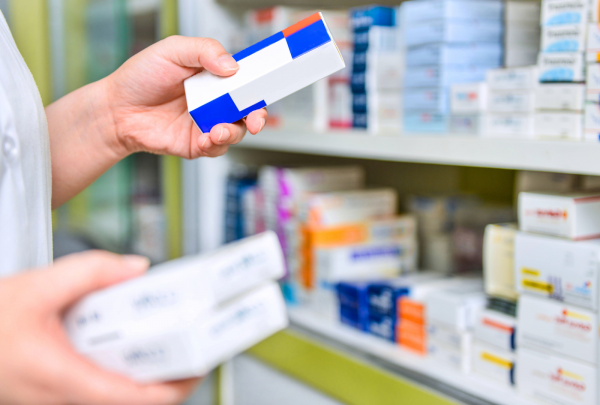 Pharmacist holding box of medication