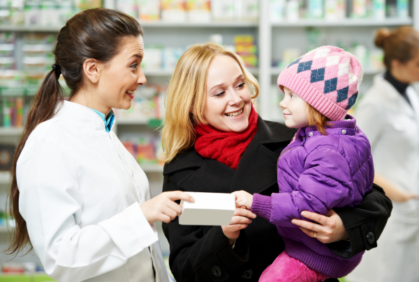 Pharmacist with a mother and child