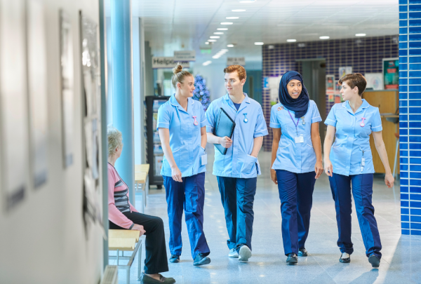 nurses walking through hallway